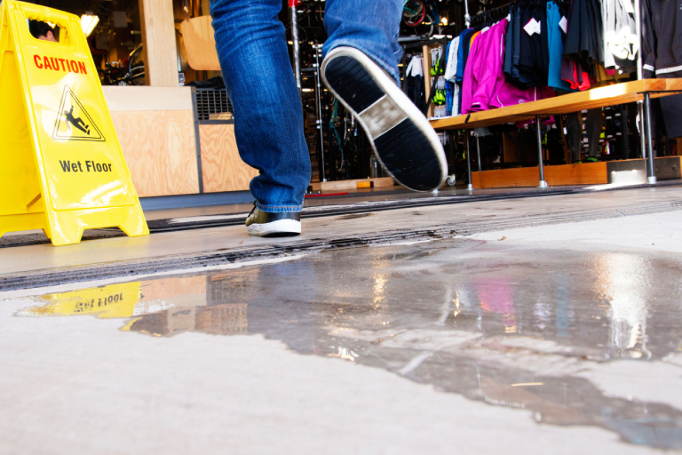 Close up of someone walking across a wet floor in a retail store