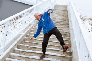 Senior man slipping on icy stairs